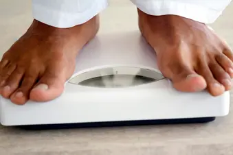 photo of man's feet on weight scale