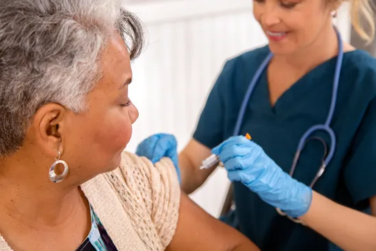 photo of senior woman receiving vaccination