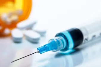 photo of Pill bottle and syringe
