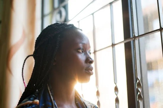 photo of woman looking out window