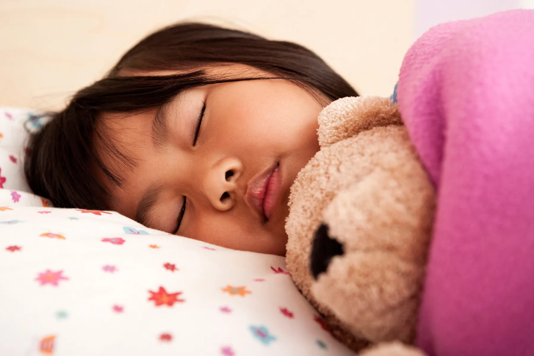 photo of young girl asleep in bed