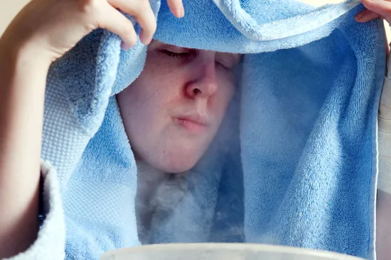 photo of inhaling steam with towel