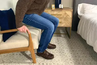 man rising from chair