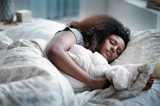 photo of woman sleeping in bed