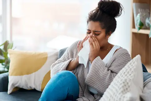 photo of woman blowing nose